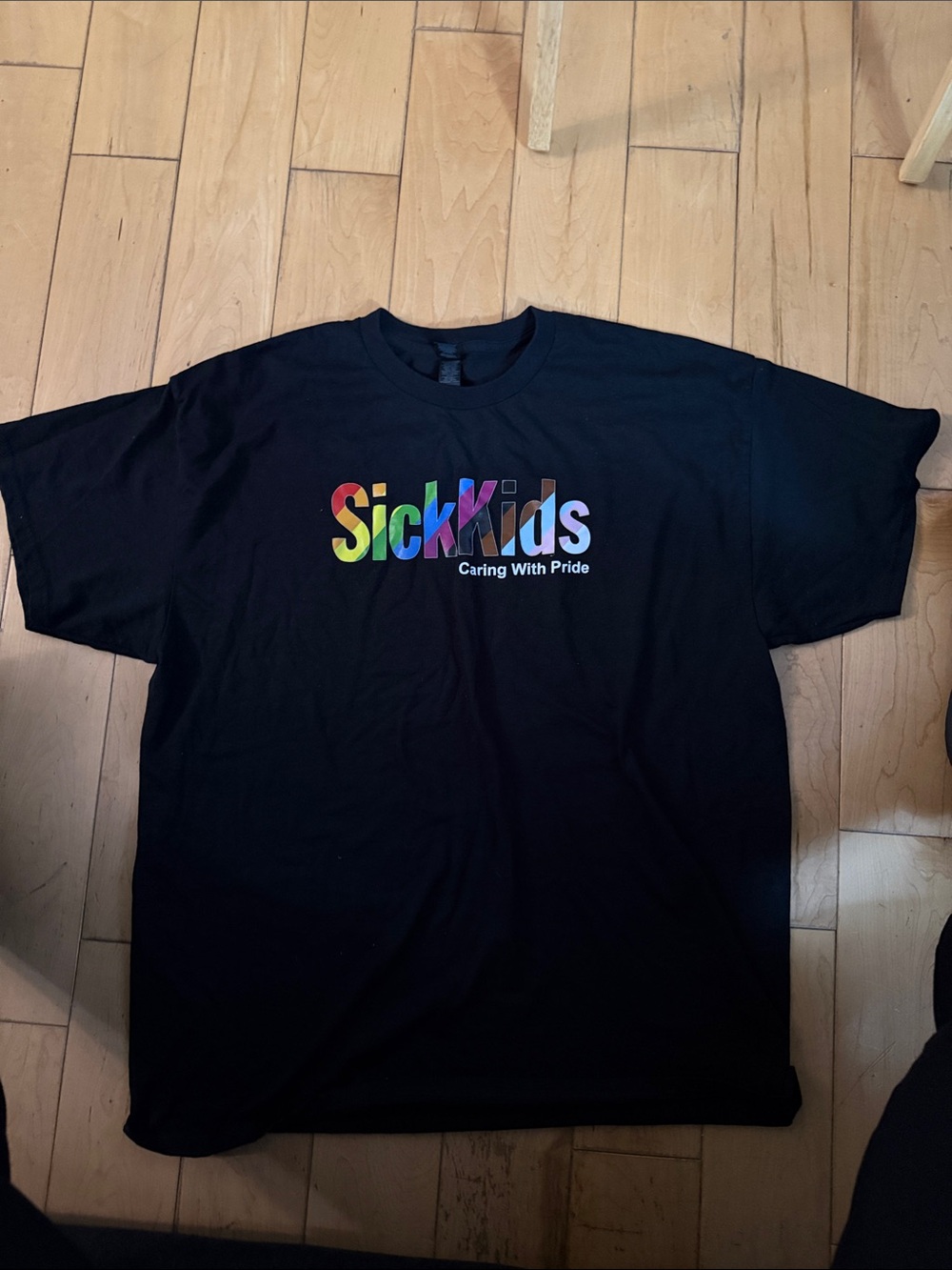 "Sick Kids Caring With Pride" Black Rainbow Logo Tee